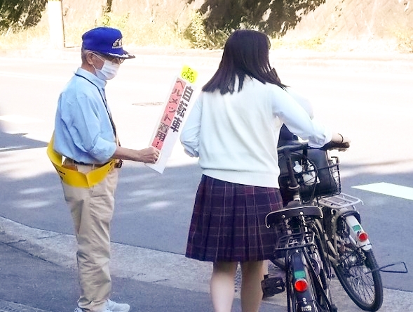 明徳高等学校前で自転車乗車時のヘルメット着用を呼び掛け！